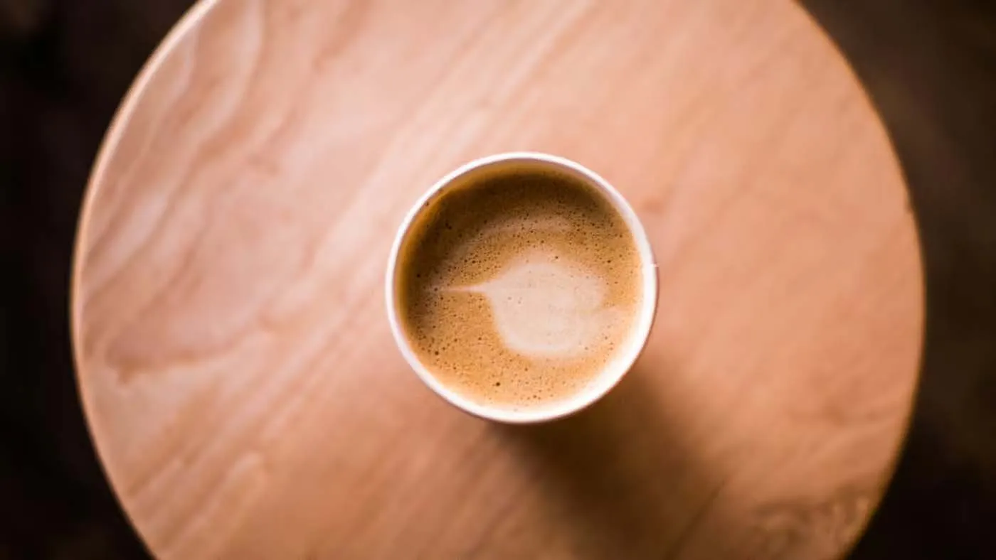 Coffee cup with latte art on a wooden table